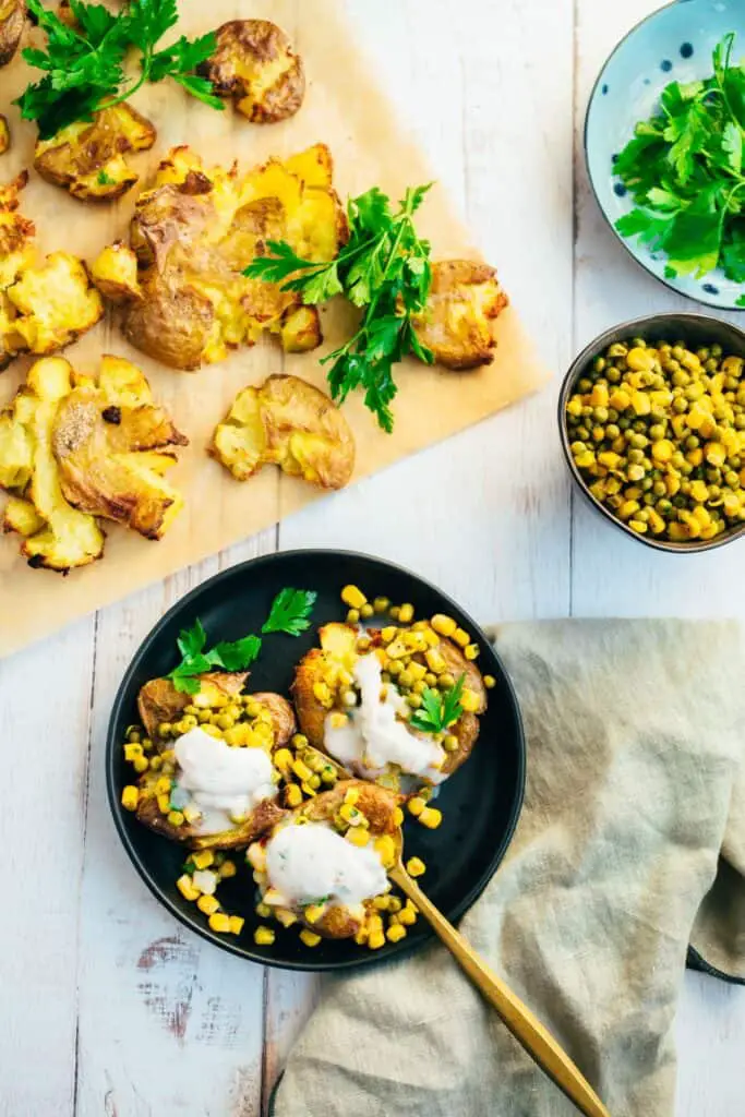 Baked potatoes with pea topping and yogurt dip