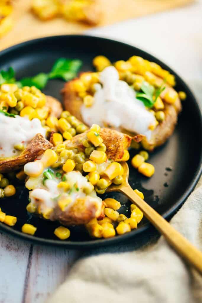 Baked potatoes with pea topping and yogurt dip